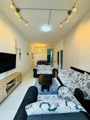 a living room with a couch and a flat screen tv at AYAAN HOLIDAY INN Homestay at Tanah Rata with PS4 gaming in Tanah Rata