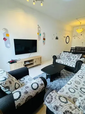 a living room with two couches and a flat screen tv at AYAAN HOLIDAY INN Homestay at Tanah Rata with PS4 gaming in Tanah Rata