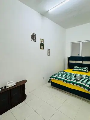 a bedroom with a bed and a telephone in it at AYAAN HOLIDAY INN Homestay at Tanah Rata with PS4 gaming in Tanah Rata