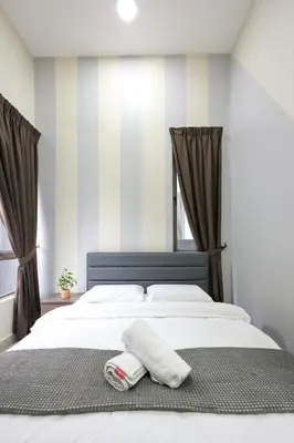 a bed with two towels sitting on top of it at Comfort Family Stay Palas Horizon Brinchang Cameron highlands -C Home Luxury A-1-03 in Brinchang