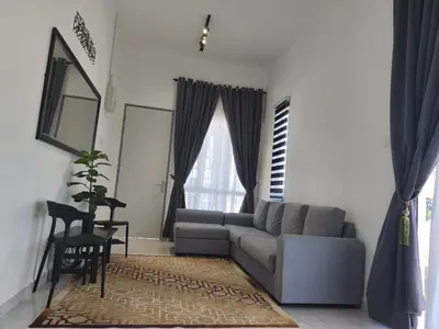 a living room with a couch and a table at Inap kluster Alamanda in Kuala Kangsar