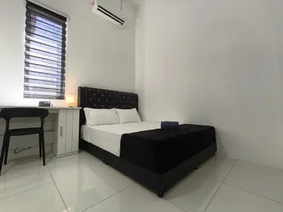 a bedroom with a bed and a desk and a chair at Inap kluster Alamanda in Kuala Kangsar