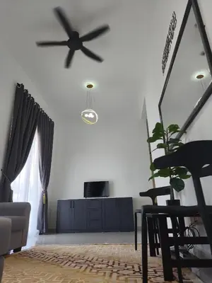 a living room with a ceiling fan and a couch at Inap kluster Alamanda in Kuala Kangsar