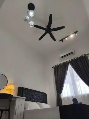 a bedroom with a ceiling fan and a bed at Inap kluster Alamanda in Kuala Kangsar