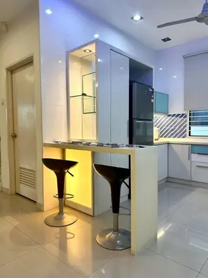 a kitchen with a counter with two stools at Raja Uda Family Haven 4BR 10 Pax in Butterworth