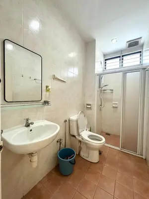 a bathroom with a sink and a toilet and a mirror at Raja Uda Family Haven 4BR 10 Pax in Butterworth