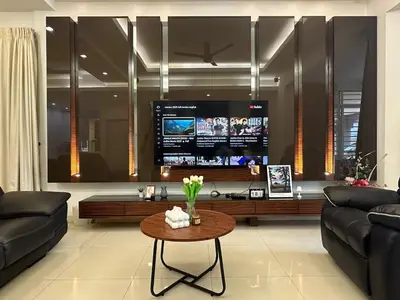 a living room with a couch and a table with a tv at Raja Uda Family Haven 4BR 10 Pax in Butterworth