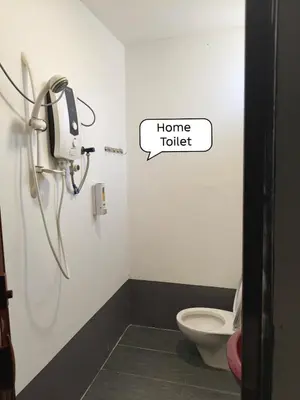 a bathroom with a toilet and a phone in a room at Putra Villa Homestay Ipoh in Ipoh