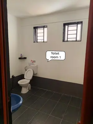 a bathroom with a toilet and a toilet room sign at Putra Villa Homestay Ipoh in Ipoh