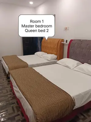 two beds in a room with a sign saying room master bedroom queen bed at Putra Villa Homestay Ipoh in Ipoh