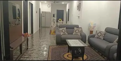 a living room with couches and a table at Putra Villa Homestay Ipoh in Ipoh