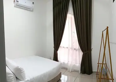 a bedroom with a bed and a window with curtains at Nuha Homestay La Casa Lunas