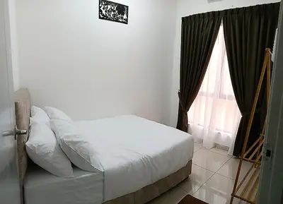 a bedroom with a white bed and a window at Nuha Homestay La Casa Lunas