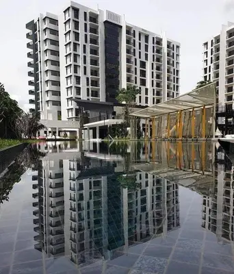 a reflection of buildings in a body of water at 3 Bed Rooms Cozy Unit The Cove in Ipoh