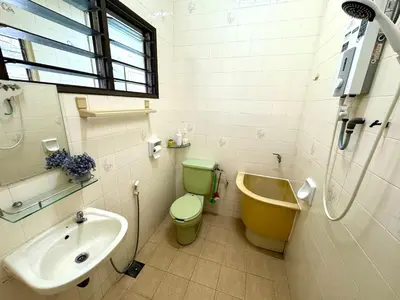 a bathroom with a green toilet and a sink at Simee Cozy Homestay ,Simee, Ipoh Town in Ipoh