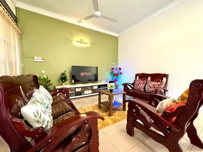 a living room with rocking chairs and a flat screen tv at Simee Cozy Homestay ,Simee, Ipoh Town in Ipoh