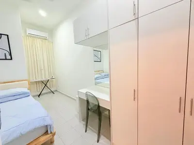 a bedroom with a bed and a desk and a table at Adam Luxe Homestay Tapah in Tapah