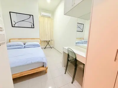 a small bedroom with a bed and a desk at Adam Luxe Homestay Tapah in Tapah