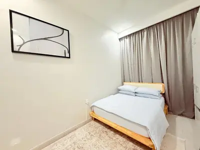 a bedroom with a bed and a mirror on the wall at Adam Luxe Homestay Tapah in Tapah