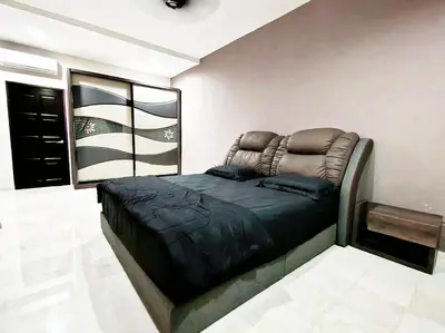 a bedroom with a bed with a leather head board at Ipoh FamilyHub by One Life Four Season Guesthouse in Ipoh