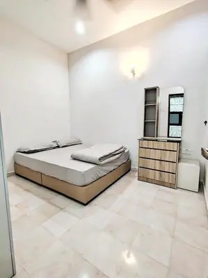 a white bedroom with a bed and a mirror at Ipoh FamilyHub by One Life Four Season Guesthouse in Ipoh