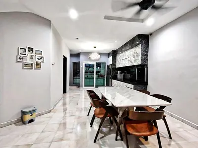 a dining room with a table and chairs at Ipoh FamilyHub by One Life Four Season Guesthouse in Ipoh