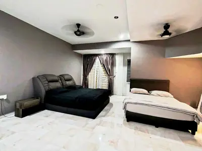 a bedroom with a black bed and a couch at Ipoh FamilyHub by One Life Four Season Guesthouse in Ipoh