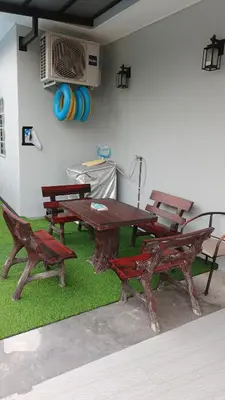 a picnic table and benches in a room at Lapangan Sentosa Homestay Ipoh in Ipoh