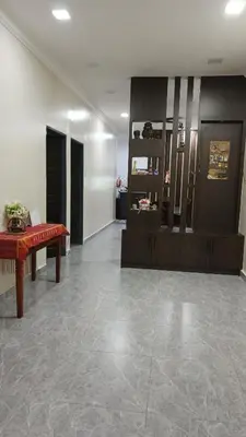 a living room with a couch and a table at Lapangan Sentosa Homestay Ipoh in Ipoh