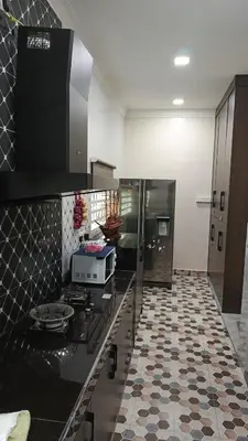 a kitchen with a stove and a counter top at Lapangan Sentosa Homestay Ipoh in Ipoh