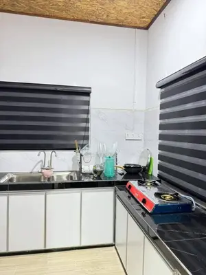 a kitchen with a sink and a counter top at Damai Homestay in Gua Sai