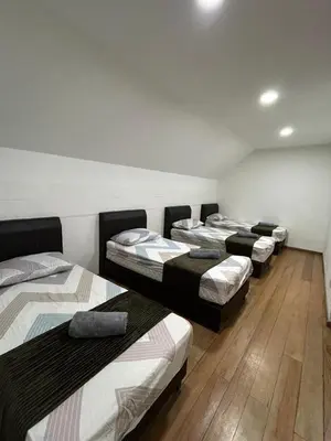 a group of four beds in a room at Ereens penthouse Cameron highland in Brinchang