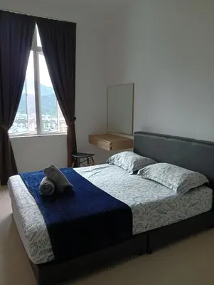 a bedroom with a bed with a towel on it at Ereens penthouse Cameron highland in Brinchang