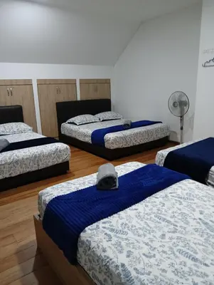 a room with three beds with a hat on them at Ereens penthouse Cameron highland in Brinchang