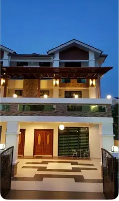 a large house with a patio in front of it at Woon homestay 2 in Balik Pulau