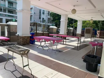 a group of pink tables on a patio at Woon homestay 2 in Balik Pulau