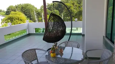 a net hanging over a table on a balcony at Woon homestay 2 in Balik Pulau