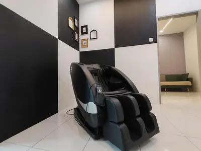 a black leather chair sitting in a room at Lahat Mines Signature Stay in Lahat