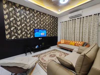 a living room with a couch and a tv at Lahat Mines Signature Stay in Lahat