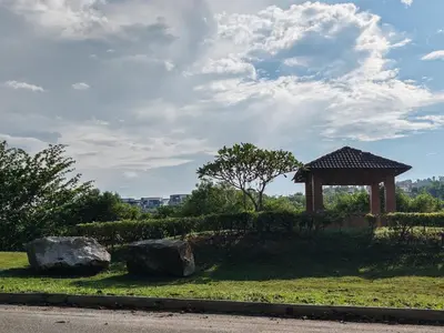 a park with a gazebo and two rocks at Lahat Mines Signature Stay in Lahat
