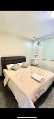 a bedroom with a large bed with a projection screen at Lumen Stay in Bukit Mertajam