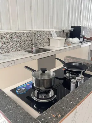 a pot on a stove in a kitchen at Lumen Stay in Bukit Mertajam