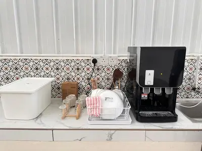a kitchen counter with a coffee maker and a mixer at Lumen Stay in Bukit Mertajam