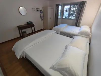 a bedroom with two beds with white pillows at Little England B5-1 Fraser Panorama in Bukit Fraser