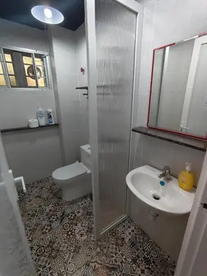 a bathroom with a sink and a toilet and a mirror at Little England B5-1 Fraser Panorama in Bukit Fraser