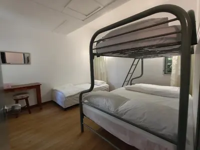 a bedroom with two bunk beds and a desk at Little England B5-1 Fraser Panorama in Bukit Fraser