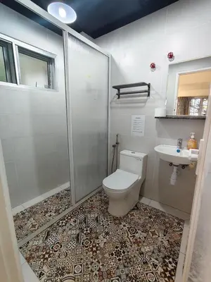 a bathroom with a shower and a toilet and a sink at Little England B5-1 Fraser Panorama in Bukit Fraser