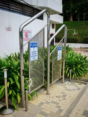 a group of metal gates with signs on them at Sri Sayang Homestay 2 in Batu Ferringhi