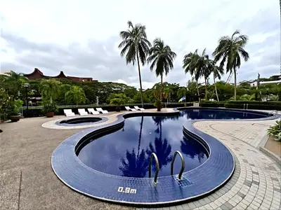 a swimming pool with two swans in the water at Sri Sayang Homestay 2 in Batu Ferringhi