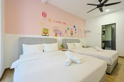 two beds in a room with white walls at SpongeBob Fun Family Homestay In Brinchang Cameron Highland Clover Home 7-02 in Brinchang